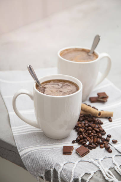 istock white porcelain coffee cup mugs handle with hot drink and coffee beans 1370591202