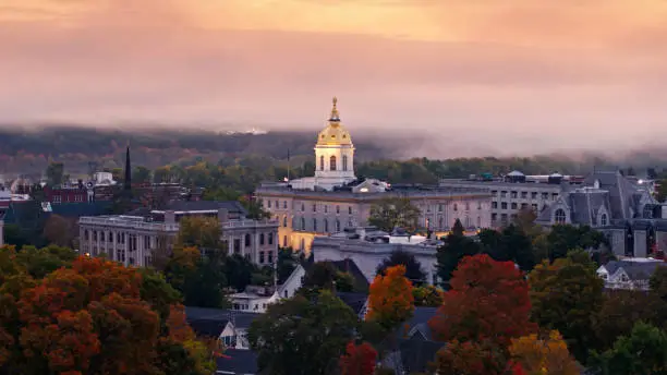 Aerial shot of the New Hampshire State House in Concord at sunrise on a misty morning in Fall.  

Authorization was obtained from the FAA for this operation in restricted airspace.