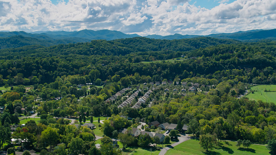 Drone shot of a residential neighborhood of Pigeon Forge, Tennessee in the shadow of the Great Smoky Mountains.