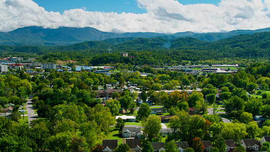 Drone view over a residential neighborhood towards Pigeon Forge, a popular vacation destination in Sevier County, Tennessee, close to Great Smoky Mountains National Park.