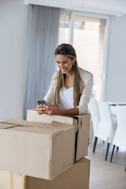 istock Woman moving house and using an app on her cell phone on a break 1370592417