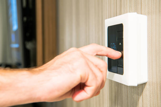 istock Setting Thermostat to Lower Temperature To Save Energy 1370594996