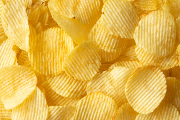 istock crispy golden potato chips snack texture background 1370595269