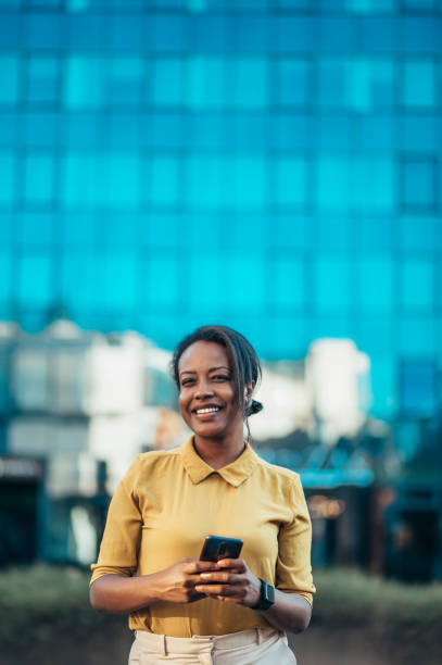 istock African american woman using a smartphone while out in the city 1370596772