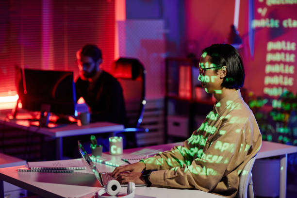 istock Contemporary young software engineer sitting by workplace in front of laptop 1370598622