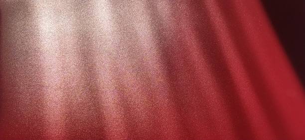 istock blurred striped red background. Play of light and shadow. Light rays. Divine or heavenly radiance from above. Simulate lighting something from above with spotlights. Copy space. 1370599920