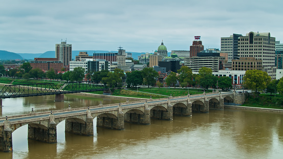 Aerial shot of Harrisburg on an overcast day in Fall, with the dome of the Pennsylvania State Capitol Building visible above the downtown office buildings.     

Authorization was obtained from the FAA for this operation in restricted airspace.