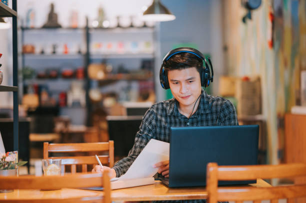 istock Asian Chinese man video call working with his laptop at cafe 1370601045