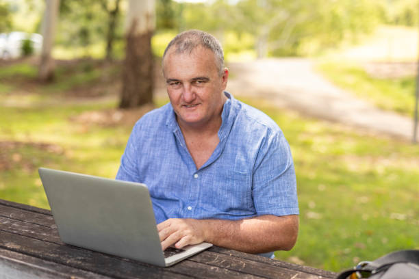 istock Entrepreneur Working on a Laptop Outdoors 1370601129