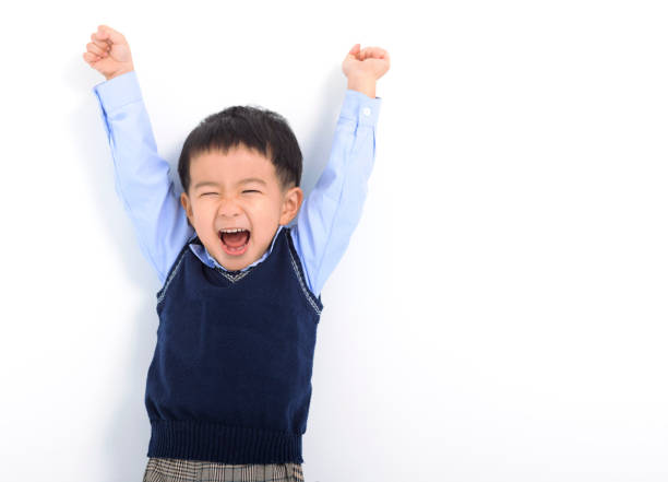 Happy Kid boy having fun on white background stock photo