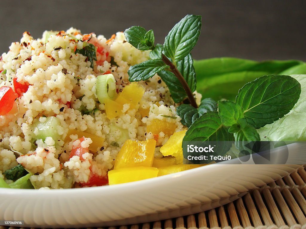 Arabian tabouleh dish with couscous Close up of a traditional Arabian dish: Tabouleh salad with couscous, tomatoes and parsley. Appetizer Stock Photo