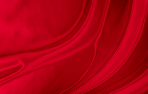 istock Black red satin dark fabric texture luxurious shiny that is abstract silk cloth background with patterns soft waves blur beautiful. 1370604664
