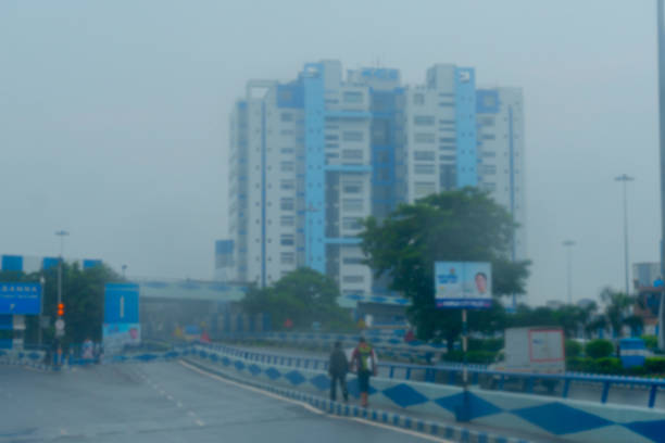 istock Blurred image of Howrah, West Bengal, India. Shot through raindrops falling on car windshield glass, Nabanna building , state administrative office. Monsoon stock image. 1370605534