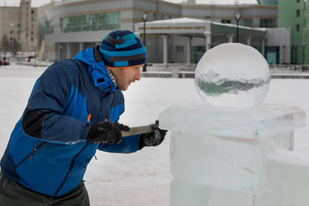 istock Portrait of a sculptor in a blue winter suit with a chisel in his hands at work 1370607056