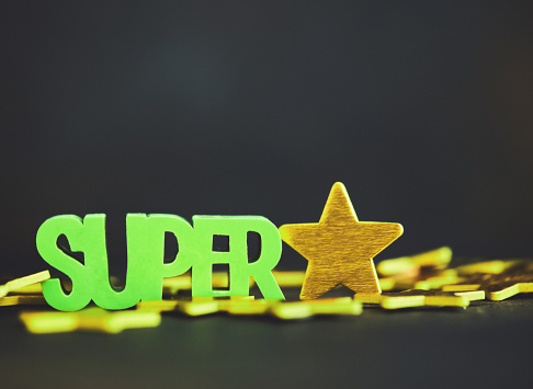 SUPER STAR. Conceptual image of the word super and gold stars. Achievement and success
