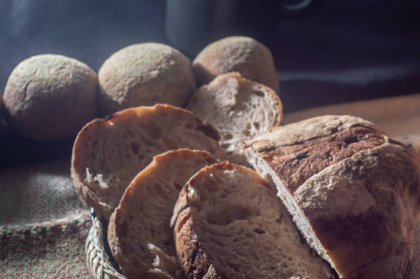 istock Table with handmade breads and coffee mug, copy space and coffee maker putting coffee in mug 1370612637