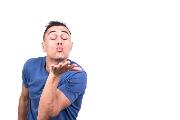 hombre soplando un beso con los ojos cerrados - blowing men kissing blowing a kiss fotografías e imágenes de stock