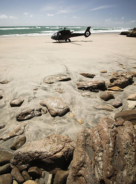 Helicopter on sandy beach, West Coast, New Zealand stock photo