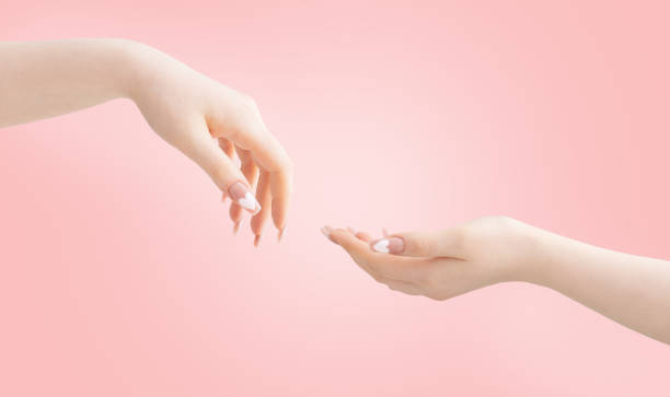 istock female hands with beautiful long nails with  manicure with  heart pattern on pink background 1370625003