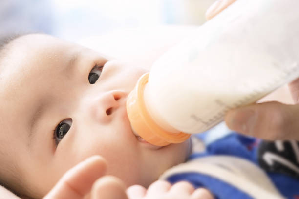 istock Asian baby drinking milk from a baby bottle 1370629800