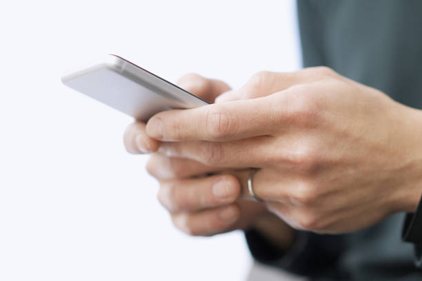 Asian man typing text on his smartphone