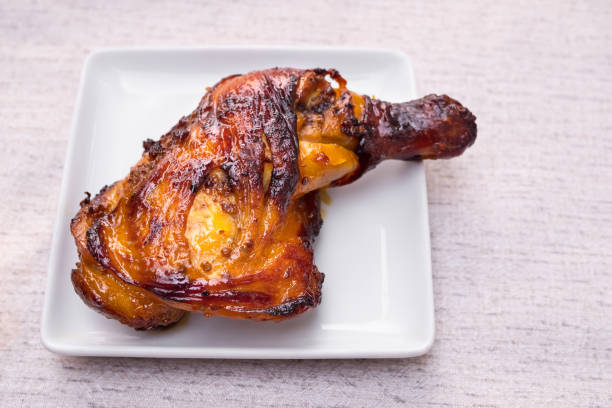istock Grilled chicken leg on white plate. 1370631883