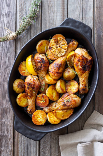 istock Baked chicken legs with potatoes and lemon. Recipe. 1370634139