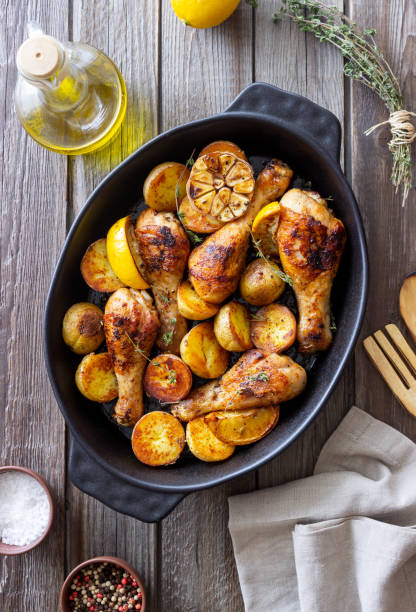 istock Baked chicken legs with potatoes and lemon. Recipe. 1370634267
