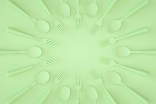 Minimal kitchen restaurant concept with kitchen utensils on green color background.