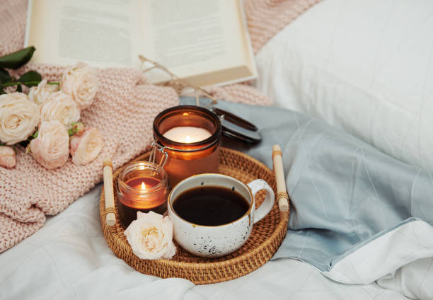 istock Tray of coffee and candles on bed. 1370638376