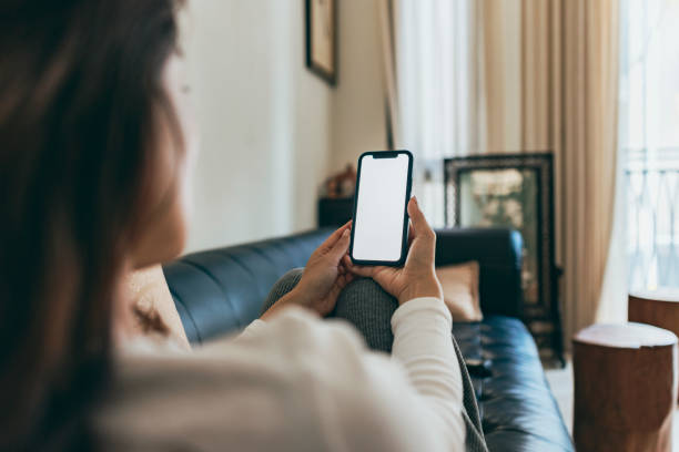 istock Asian woman using smartphone at home 1370639554