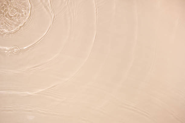 transparent beige colored clear calm water surface texture