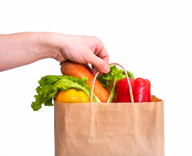 istock Bag with grocery purchase holding a man's hand on a white background. 1370641317