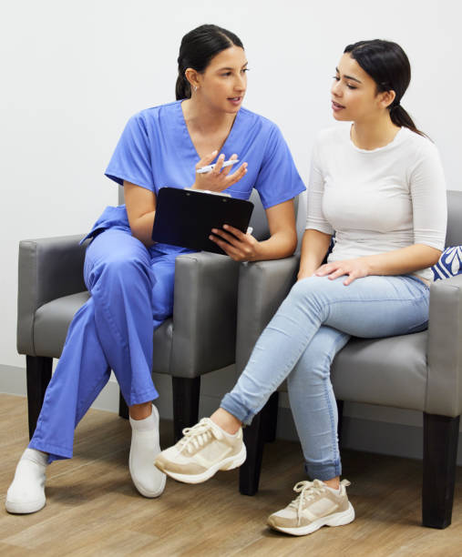 shot of a dentist and patient talking in a office - medical assistant imagens e fotografias de stock