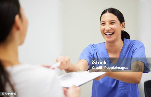 Shot Of A Patient And Assistant Interacting In A Dentist Office Stock Photo - Download Image Now