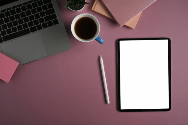 istock Digital tablet, stylus pen, laptop computer and coffee cup on purple background. 1370642323