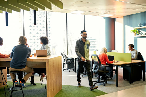 istock Diverse group of business people working in open plan office 1370642430
