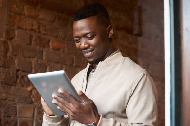 istock Shot of a businessman using his digital tablet while at a cafe 1370643009