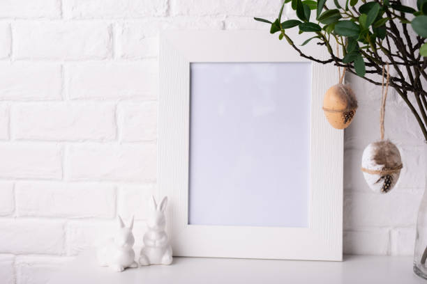 istock Mock up Photo frame near a white brick wall with Easter decor. 1370643876