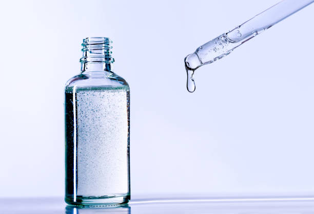 istock dropper with serum with a dropping drop into the bottle 1370644046