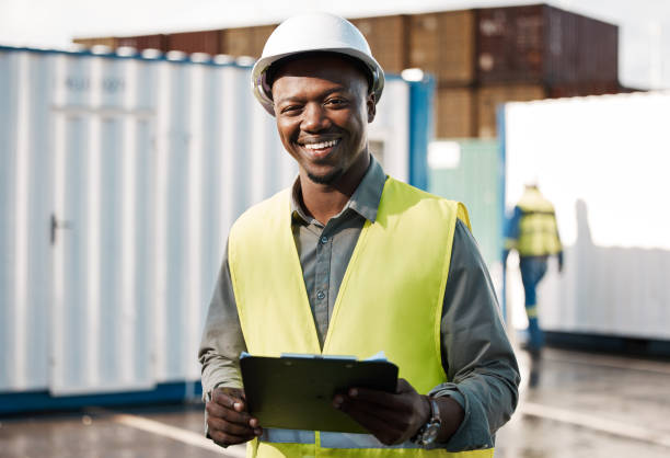 Shot of a young construction site worker checking his clipboard
