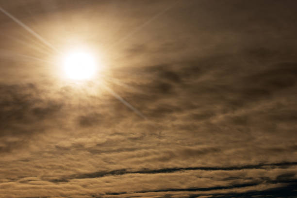 A low angle shot of a beautiful cloudscape partially blocking sunshines