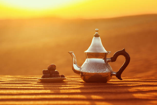 istock Arabian teapot and dates in the desert at a beautiful sunset symbolizing Ramadan 1370648216