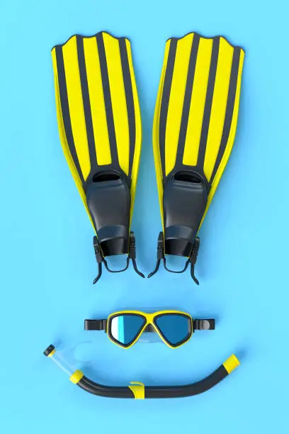 Photo of Colorful scuba mask, flippers and snorkeling tube on blue background
