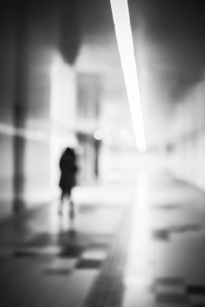 istock Blurry human silhouette in a subway. Moving human silhouettes in blur. 1370649016