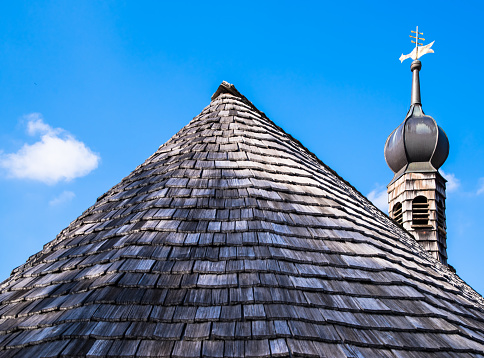 Aperture 8, exposure time 1/250 sec., focal length 45 mm, UV filter, sun visor, roof shingles on a wooden church,