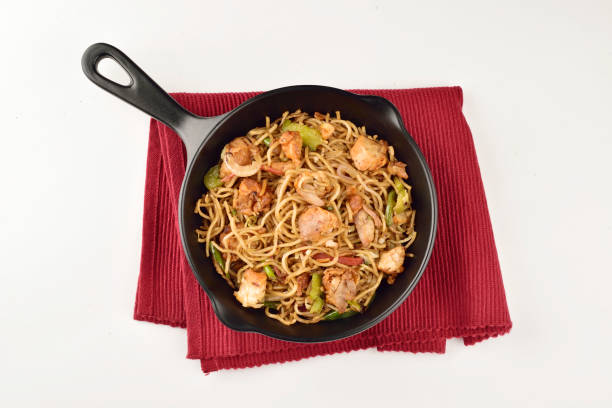 top view of chicken chowmein in pan isolated on white background stock photo