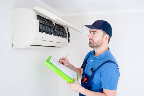 istock Technician with clipboard checking air conditioner for installation estimate 1370656897
