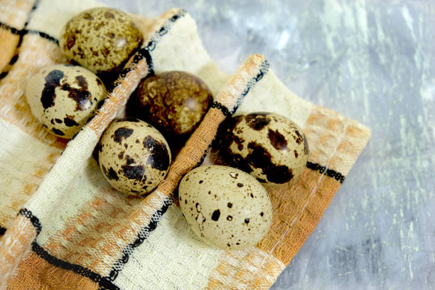 Quail eggs on wooden background. Happy Easter