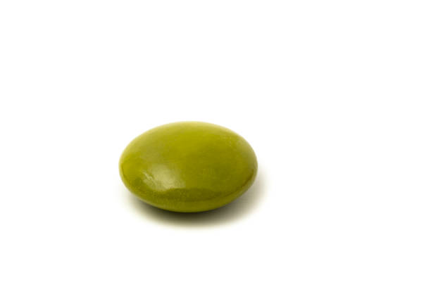 Macro shot of green candy isolated on white background.